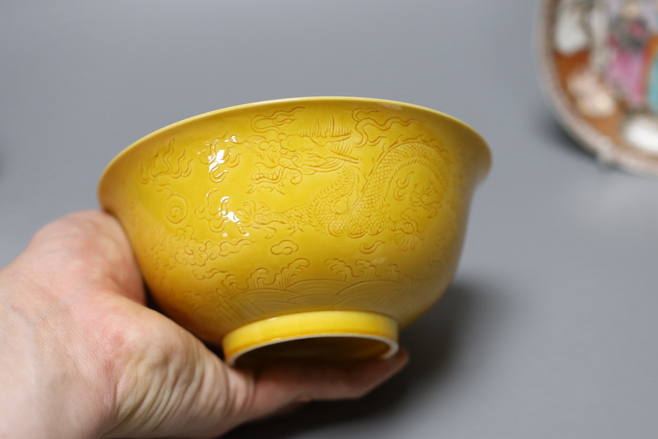 An 18th century Chinese export saucer dish (a.f), a Chinese blue and white dish and yellow ground ‘dragon’ bowl
